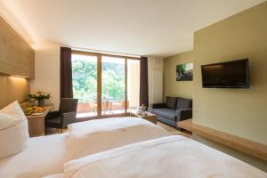 um quarto de hotel com uma cama e uma televisão em Hotel-Restaurant Ruland em Altenahr