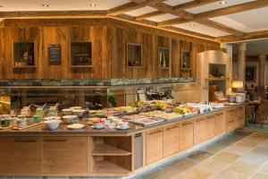 a large kitchen with a buffet of food at Hotel Lumberger Hof in Grän