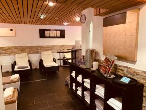 a waiting room with chairs and a counter with towels at Schlosshotel Landstuhl in Landstuhl