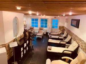 a salon with couches and chairs in a waiting room at Schlosshotel Landstuhl in Landstuhl