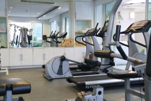 a gym with several treadmills and elliptical machines at FuramaXclusive Asoke, Bangkok in Bangkok