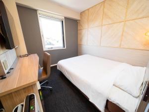 Voodi või voodid majutusasutuse Super Hotel Nagaizumi Numazu Inter toas