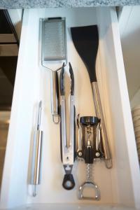 a group of kitchen utensils in a drawer at Apartment Panorama in Saalbach Hinterglemm