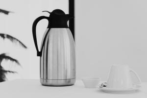 a black and white photo of a tea kettle and a tea cup at Pravi Hotel in Eleftheroúpolis