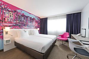 
A bed or beds in a room at WestCord Art Hotel Amsterdam 3 stars
