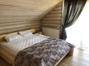 a bedroom with a bed in a wooden room at Saltzbork in Staraya Solʼ