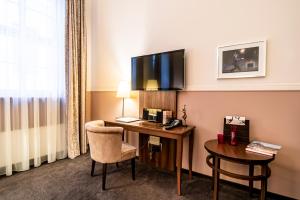 TV a/nebo společenská místnost v ubytování Aparthotel Am Schloss