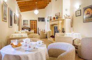 a dining room with tables and chairs and a fireplace at Hotel Tossal d'Altea in Altea