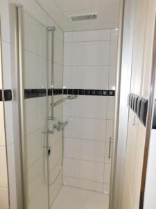 a shower with a glass door in a bathroom at Sonnenschein 2 inkl Strandkorb vom 01 05-01 10 in Grömitz