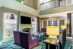 a living room with purple chairs and a fireplace at La Quinta by Wyndham Raleigh Durham Intl AP in Morrisville