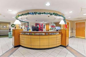 a lobby with a christmas wreath over a counter at La Quinta by Wyndham Boston Somerville in Somerville