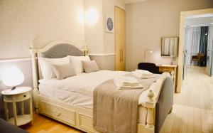 a bedroom with a large white bed with white pillows at JessApart– Babka Tower Apartment in Warsaw