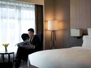 Letto o letti in una camera di Pullman Shanghai Xuhui