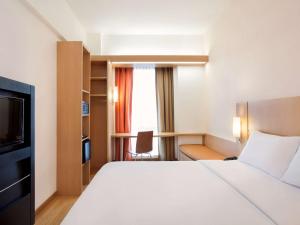 A bed or beds in a room at Ibis Bandung Trans Studio