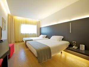 Posteľ alebo postele v izbe v ubytovaní Mercure Nerocubo Rovereto