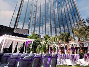 a group of purple chairs in front of a building at Pullman Guiyang in Guiyang