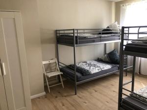 a room with three bunk beds and a chair at Ferienwohnung Mook in Rodenbach