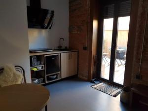 a living room with a door open to a patio at 13 suites in León
