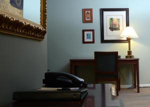 a office with a telephone and a desk with a lamp at Rosellen Suites at Stanley Park in Vancouver