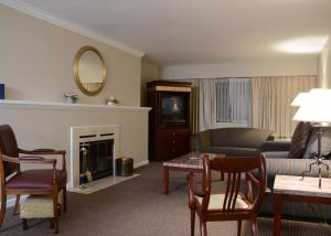 a living room with a couch and a fireplace at Rosellen Suites at Stanley Park in Vancouver