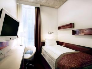 a hotel room with two beds and a television at Ibis Styles Stockholm Odenplan in Stockholm
