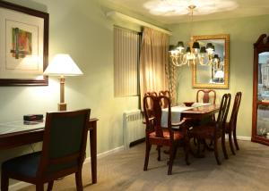 a dining room with a table and chairs at Rosellen Suites at Stanley Park in Vancouver