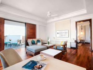 a living room with a couch and a table at Pullman Danang Beach Resort in Danang