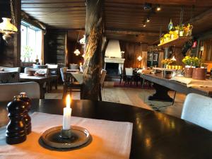 
a candle is lit on a table in a restaurant at Gammelgården in  Högfjället
