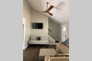 a living room with a couch and a ceiling fan at Modern Home:3 Bedroom;2.5 Bath Near M-Benz Stadium in Atlanta