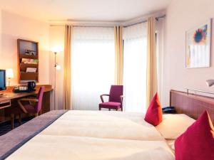 Un pat sau paturi într-o cameră la Mercure Hotel Dortmund Messe