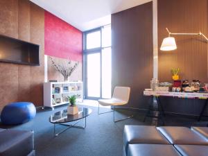 a living room with a couch and a table at Ibis Styles Roma Eur in Rome