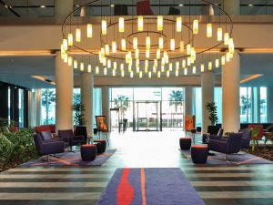 a lobby with a large chandelier in a building at Mercure Nador Rif in Nador