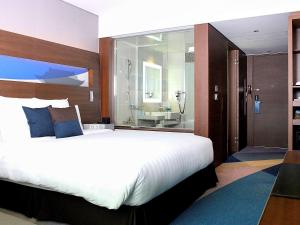 A bed or beds in a room at Novotel Ambassador Suwon