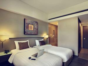 Postel nebo postele na pokoji v ubytování Mercure Bali Legian