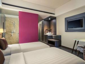 Postel nebo postele na pokoji v ubytování Mercure Bali Legian