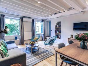 a living room with a couch and a table and chairs at Mercure Paris Opera Grands Boulevards in Paris