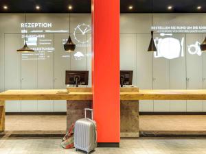 a suitcase is sitting in front of a waiting room at Ibis Berlin Hauptbahnhof in Berlin