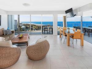 a living room with a view of the ocean at The Sebel Maroochydore in Maroochydore
