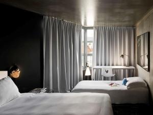 
a hotel room with a bed and a window at Mama Shelter Paris East in Paris
