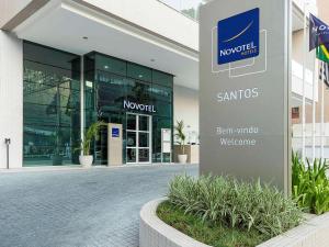 a building with a sign in front of it at Novotel Santos Gonzaga in Santos