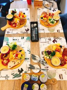 a wooden table with plates of food on it at 茶田關舍民宿Tea Paddy B&B in Guanshan