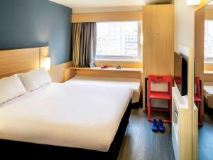 Postel nebo postele na pokoji v ubytování ibis Copacabana Posto 5