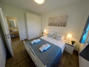 a bedroom with a bed with two towels on it at Villa NOAH - 4 bedrooms, 4 bathrooms, heated inside pool, jacuzzi, sauna, gym in Kornić +31 photos