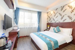 Llit o llits en una habitació de YIMI Hotel Guangzhou International Convention and Exhibition Center Guangzhou Tower Branch