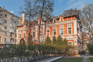 un edificio blanco y naranja con árboles delante de él en Axis.Moscow Island en Moscú