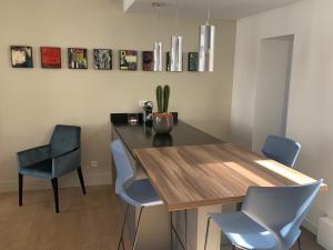 a dining room with a table and blue chairs at Paddy's Place in Lille