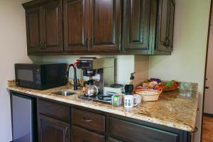 a kitchen with a counter top with a microwave and a sink at Hidden Meadows Bed and Breakfast in Stillwater