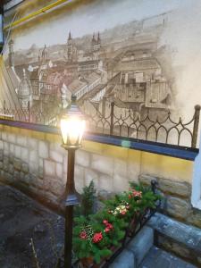 a street light in front of a wall with a mural at RynOK 25 Deluxe Lviv Center in Lviv