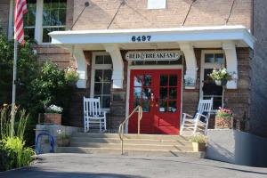 a brick building with a red door with a sign on it at Northside School Bed & Breakfast in Bonners Ferry