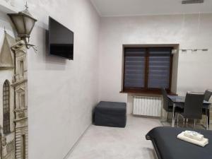 a dining room with a table and a television on a wall at RynOK 25 Elite Lviv Center in Lviv